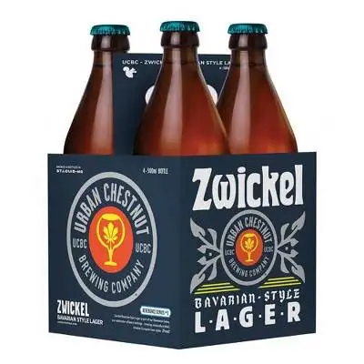 Four cans of Urban Chestnut Zwickel Bavarian-style lager beer on a wood table